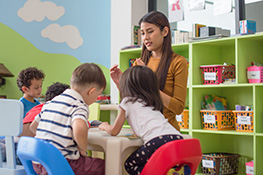 Female teacher in classroom with children