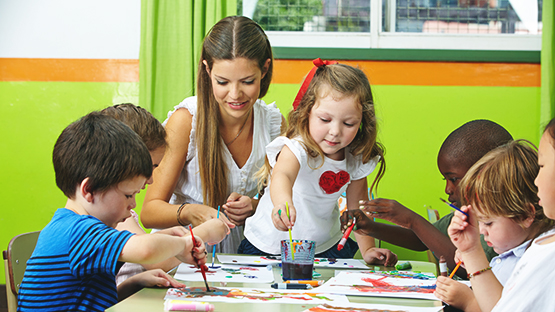 Teacher working with children