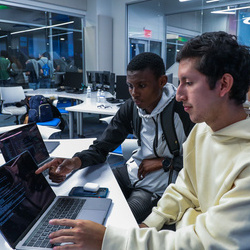 Cybersecurity classroom with computers desks and students sitting