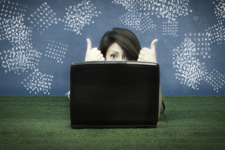 Girl working behind laptop