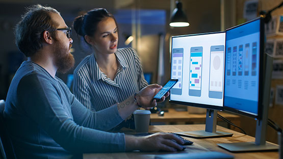 Man and woman working on a mobile app